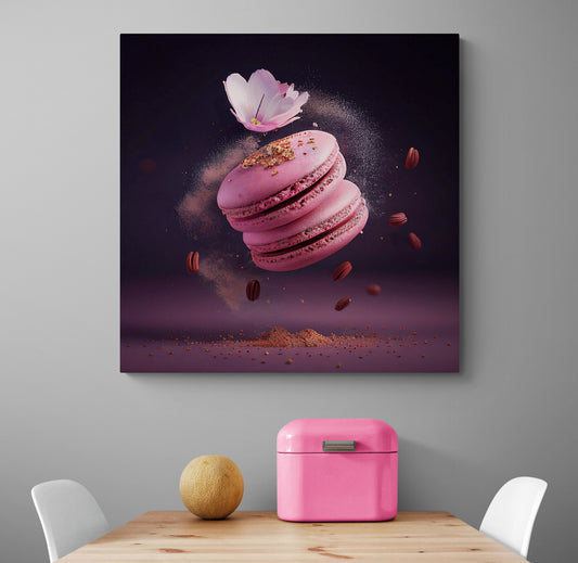 Une cuisine aux tons blanc et épuré où est accroché un tableau cuisine de deux macarons roses flottant dans une explosion de saveurs, avec du sucre en poudre et du pollen doré autour. Une fleur de sakura ajoute une touche fleurie à cette gourmandise artisanale. Le focus est sur les formes douces des macarons et l'énergie de l'explosion en arrière-plan