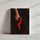 Une main féminine tenant un escarpin rouge vif avec une robe noire en arrière-plan. L'image est marquée par le texte "with love" en bas à droite.