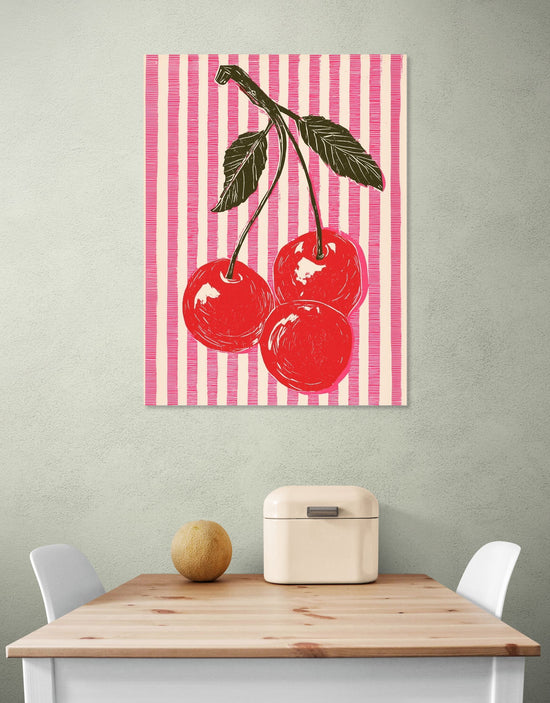 Tableau mural cerises rouges sur fond rayé rose, style pop art dans cuisine moderne